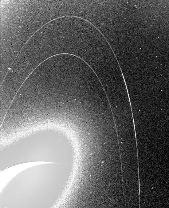 Neptune's rings captured by Voyager 2 in 1989 — the first detailed view of the planet's faint ring system.